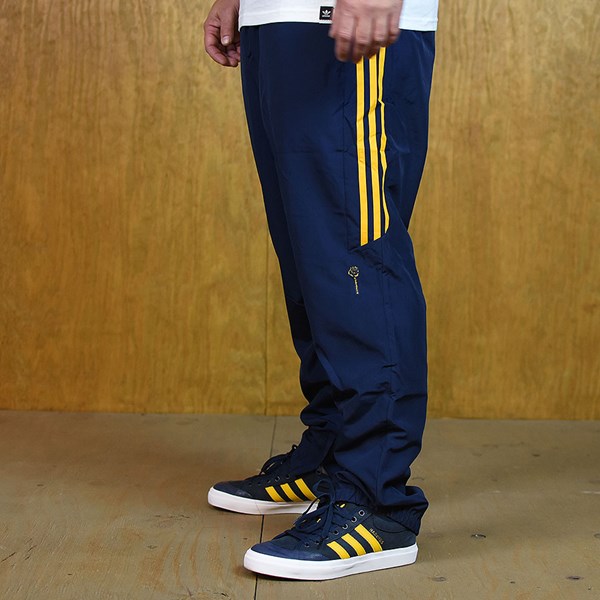 blue and yellow adidas track pants